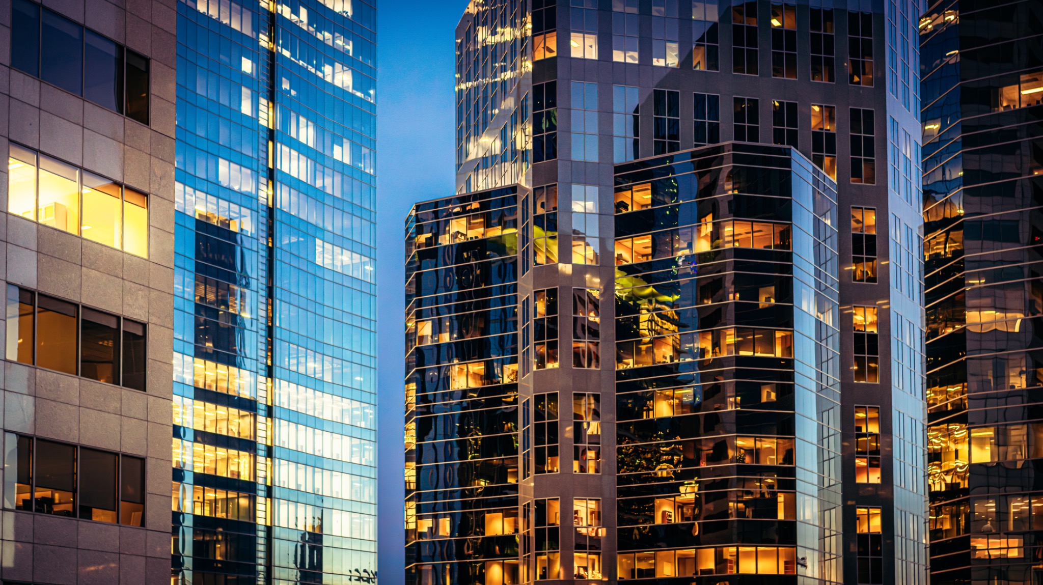 Illuminated commercial buildings representing Solanique Group advisory perspective.
